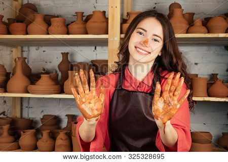 A Beautiful Potter Girl Works With Clay And Makes A Pot Of Mastre. A Woman Works With Clay On A Pott