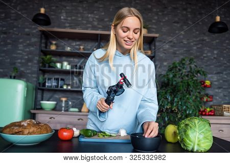 Young Beautiful Blonde Takes On Videos As She Cooks In The Kitchen