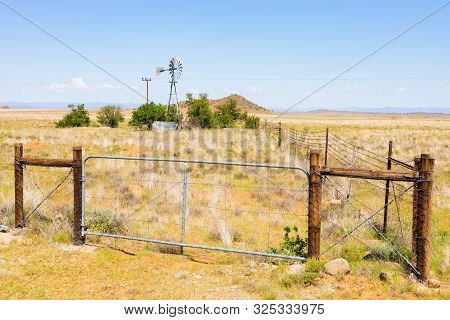 Windmill Windpump On A Farm In Rural Grassland Area Of South Africa