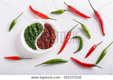 Hot Chili Pepper Paste. Red And Green Sauce On White Background. Adjika Or Ajika In Georgian Cuisine