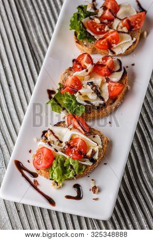 Bruschetta With Tomatoes, Lettuce, Camambert, Balsamic Vinegar
