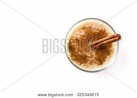 Homemade Eggnog With Cinnamon In Glass Isolated On White Background. Typical Christmas Dessert. Top 
