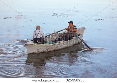 Poti, Georgia - 01.09.2019: A Litte Boat And The Fishermen On The Lake In Paliastomi. Poti.