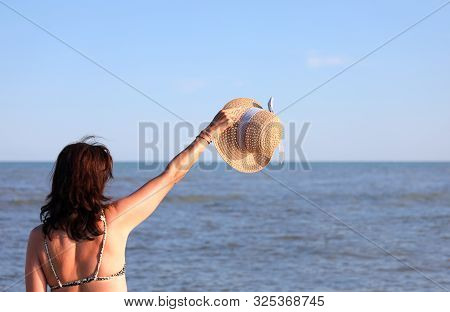Young Pretty Woman With Boater By The Blue Sea In Summer