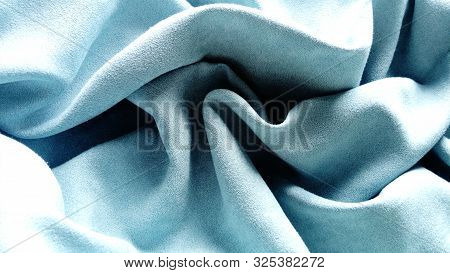 Blue Velvet Fabric Carelessly Folded And Wrinkled. Blue Canvas