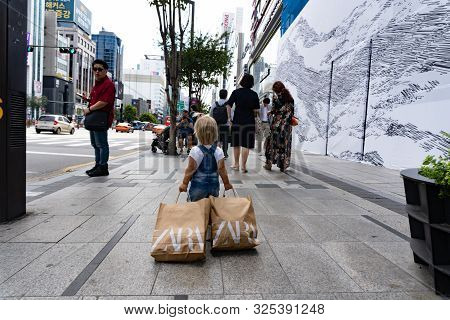 Seoul, South Korea, September 19, 2019, Small Child Bought A Lot Of Clothers At Famous Store At Blac