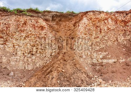 Funnel In Limestone Rocks Clogged With Earth, View On Cut