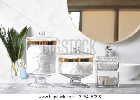 Cotton Balls, Swabs, Pads And Soap Bars On Light Grey Marble Table In Bathroom