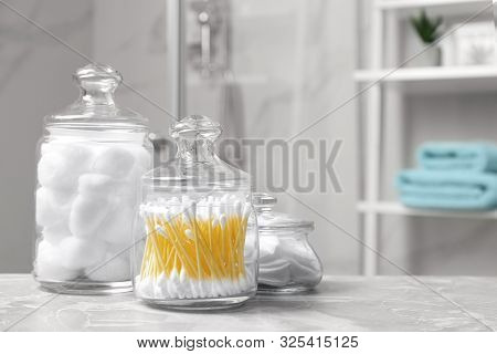 Cotton Balls, Swabs And Pads On Light Grey Marble Table In Bathroom