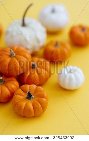 Halloweeen Theme With A Pumpkins On A Yellow Background