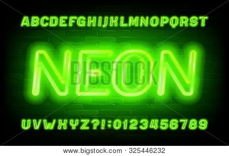 Neon Alphabet Font. Green Neon Light Letters And Numbers On Brick Wall Background. Stock Vector Type