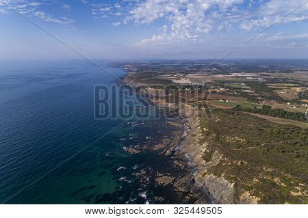 Aerial View Of The Coastline And Cliffs Near The Esteveira Beach In Aljezur, Algarve.