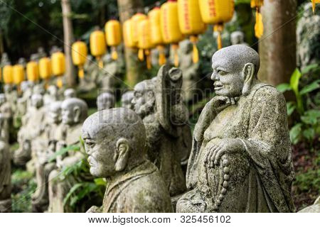 groups of buddhist arhat stone statue in the garden