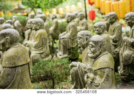 groups of buddhist arhat stone statue in the garden