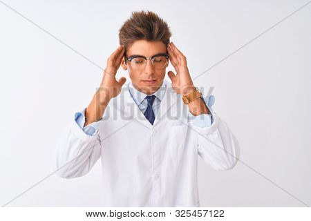 Young handsome sciencist man wearing glasses and coat over isolated white background with hand on headache because stress. Suffering migraine.