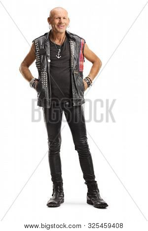 Full length portrait of a punker in leather clothes standing and smiling isolated on white background