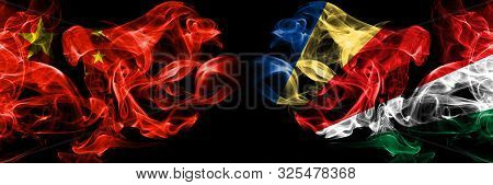 China Vs Seychelles, Seychelloise Smoke Flags Placed Side By Side. Thick Colored Silky Smoke Flags O