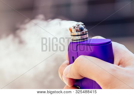 Purple Vape In A Mans Hand On A Modern Background