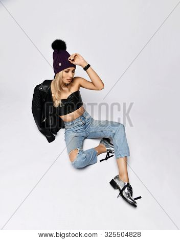 Grunge Style Brutal Blonde Woman In Torn Jeans, Leather Bralet, Leather Jacket With Zippers And Chro