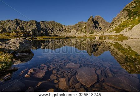 Mountain Landscape And Glacial Taul Portii Lake In Retezat National Park, Carpathian Mountains, Roma