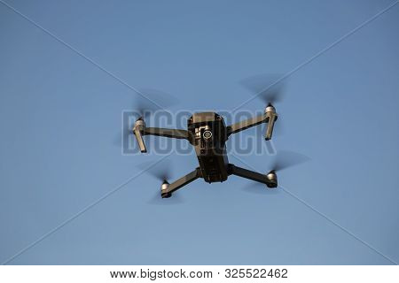 Flying Quadrocopter Drone In The Sky. Aerial Photography.