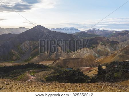 Colorful Rhyolit Landmannalaugar Mountain Panorma With Multicolored Volcanos And Volcanic Lake At Fj