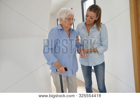 Homehelp girl assisting elderly woman 