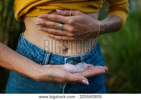 Adult Woman Is Holding Two Yoni Eggs For Vumfit, Imbuilding Or Meditation Are Made From Pink Quartz 