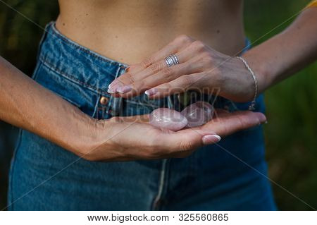 Adult Woman Is Holding Two Yoni Eggs For Vumfit, Imbuilding Or Meditation Are Made From Pink Quartz 
