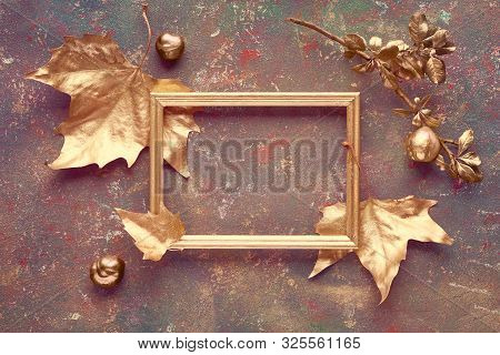 Autumn Flat Lay With Sycamore Leaves Painted Gold And Copy-space In Golden Frame On Dark Textured Ca
