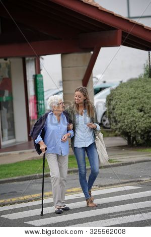 Homehelp woman shopping with elderly lady