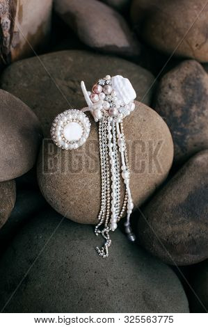 Beautiful Stud Earrings On The Stone. Stock Photo