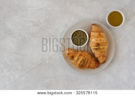 Fresh Croissants With Zaatar And Olive Oil On Light Stone Background. Top View