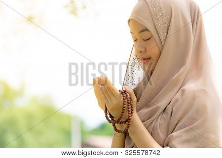 Young Adult teenager Woman making Duas for Muslim god blessing prayer.