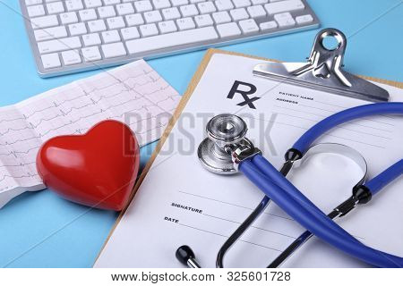 Medical Stethoscope And Red Heart Lying On Cardiogram Chart Closeup. Medical Help, Prophylaxis, Dise