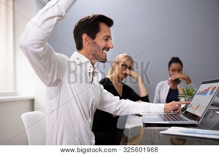 Man Raising Arm With Sweaty Armpit At Office Meeting