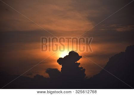 Sun Rise And Sun Set Background, Yellow, Black And Orange Clouds In The Sky.