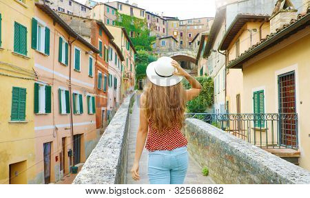 Discovering Italy. Back View Of Young Attractive Woman Walking In Old Italian City.