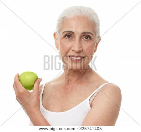 Portrait Of Beautiful Mature Woman With Apple On White Background
