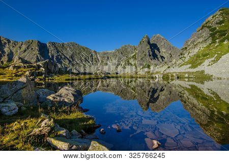 Mountain Landscape And Glacial Taul Portii Lake In Retezat National Park, Carpathian Mountains, Roma
