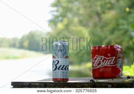 Sumy, Ukraine - August 10, 2019: Budweiser Bud Beer Can On Old Wooden Table Outdoors At The River An