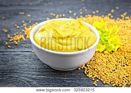 Sauce Mustard In Bowl With Seeds And Flower On Board