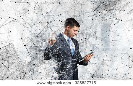Business Person Pointing On Abstract Network Structure. Standing Personal Assistant In Business Suit