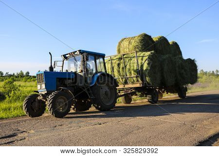 Tractor Driven Fresh Hay Rolled, After Seasonal Harvesting