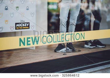 United Colors Of Benetton Brend Sign On City Street. Signboard Logo Of Benetton Group S.r.l. Global