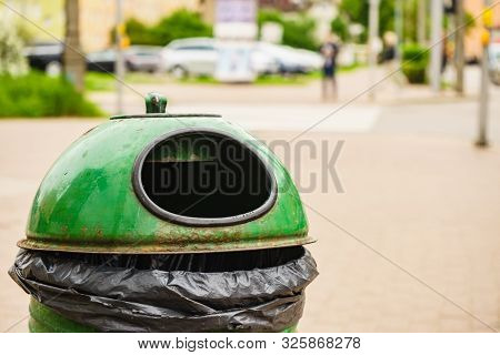 Green Pastic Garbage Bin Or Can On City Street