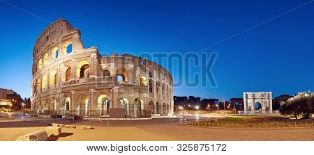 Colosseum (coliseum) In Rome, Italy, At Night. Panoramic Image With Copy-space