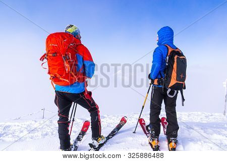 Zakopane, Tatra Mountains, Poland - December 16, 2019 Two Mountain Skiers Travelers With Large Backp