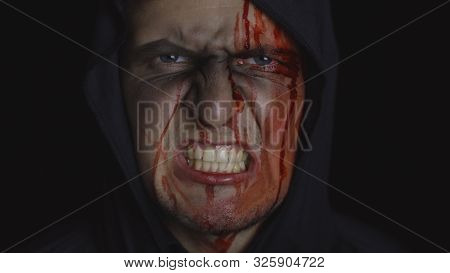 Executioner Halloween Man Portrait. Angry Aggressive Guy With Dripping Blood On His Face. Executione