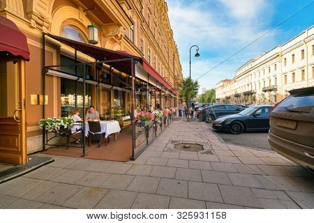 SAINT PETERSBURG, RUSSIA - CIRCA AUGUST, 2017: people sit outside a restaurant in Saint Petersburg.